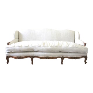 Antique French Country Louis XV Sofa in Belgian Linen With Carved Wood Detail For Sale