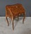 This small marquetry lady's desk, crafted in the Louis XV style, boasts a delicately curved silhouette. Its surfaces are...