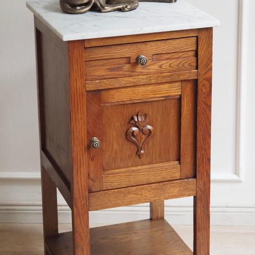 This French bedside table dates from around 1900 and belongs to the late Historicist style with a regional French...