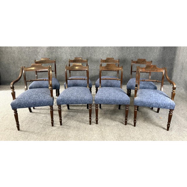 This set of 8 19th century solid mahogany dining chairs showcases elegant turned legs, classic tablet backs, and finely...