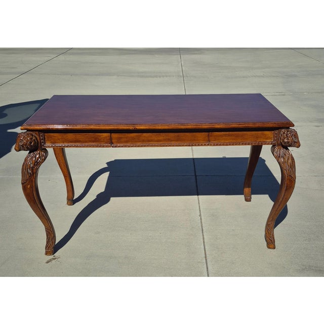 This is a vintage Chippendale or French-style walnut writing desk showcasing highly ornate period-style craftsmanship. Key...