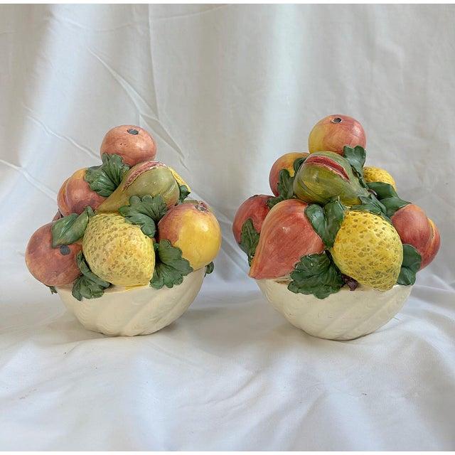 This is a pair of vintage Italian trompe l’oeil ceramic fruit topiaries, capturing the whimsy of mid-century Italian art...