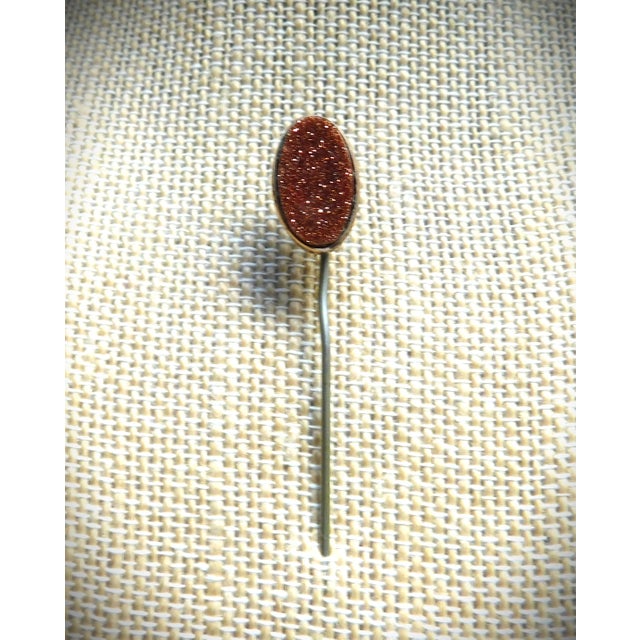 Beautiful late 19th C. Antique Goldstone stickpin in a 9K gold frame. Goldstone, a man-made glass with tiny copper flakes,...