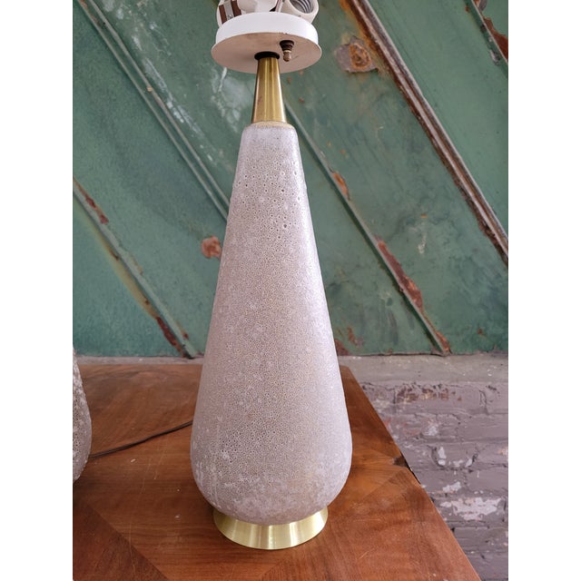 Rare pair of mid century modern ceramic table lamps with brass accents by Gerald Thurston for lightolier with a gorgeous...