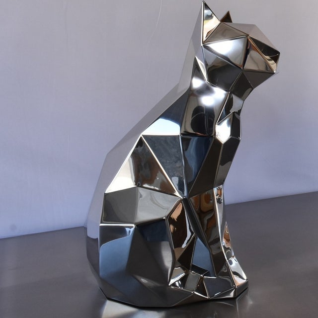 A striking life-size geometric cat sculpture handcrafted from mirror-polished stainless steel. Inspired by contemporary...