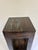 This solid pine stand features a two-tier open design with a square tabletop above a lower shelf, finished in a rich dark...