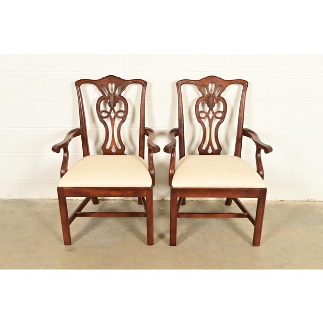 A gorgeous pair of Georgian or Chippendale style armchairs or dining captain chairs By Henredon USA, Circa 1980s Carved...