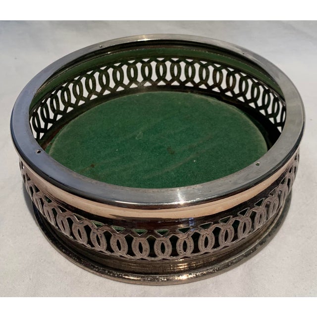 Vintage 1940s wine bottle coaster. Silverplate with wood bottom lined with felt on the underside.