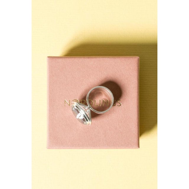 Beautiful silver ring in a strikingly elegant design by Anders Högberg, with a large rock crystal stone in an elevated...