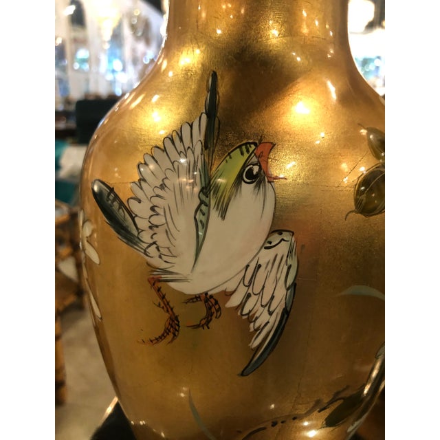 Lovely pair of vintage chinoiserie table lamps. Lovely gold leaf, birds, flowers, wood base, brass pagoda top. Newly wired...