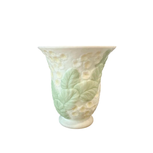 A vintage, art glass vase attributed to Phoenix Consolidated. Features a tapered, molded glass vase adorned with hydrangea...