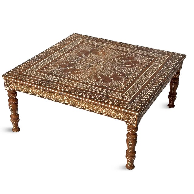 Vintage square Indian teak wood coffee table. Showcases intricate hand-laid inlay work across the top, apron, and turned...
