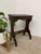 This vintage decorative wood stool features a compact rectangular top and sculpted side panels, offering a traditional...