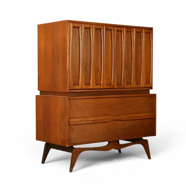 This 1960s Tobago highboy dresser is a sculptural example of Canadian mid century modern design, built in walnut with a...
