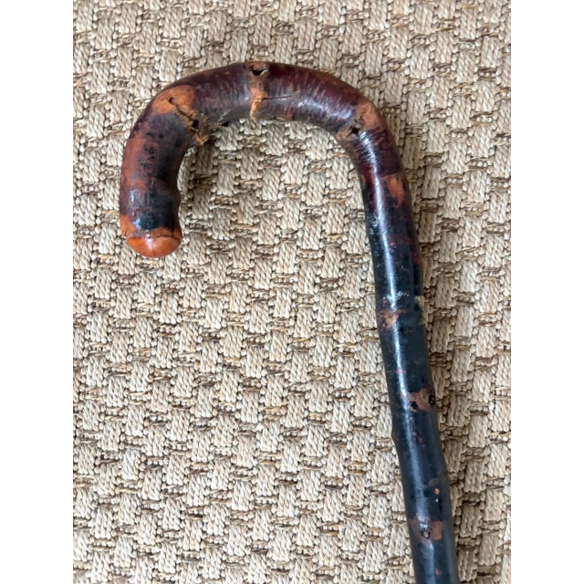 An unusual walking cane, hand-carved from knobby burlwood. A unique piece to add to your collection. Aged to perfection. I...