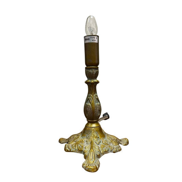 This charming vintage cast brass table lamp features an elegant, classical silhouette with richly detailed foliate and...