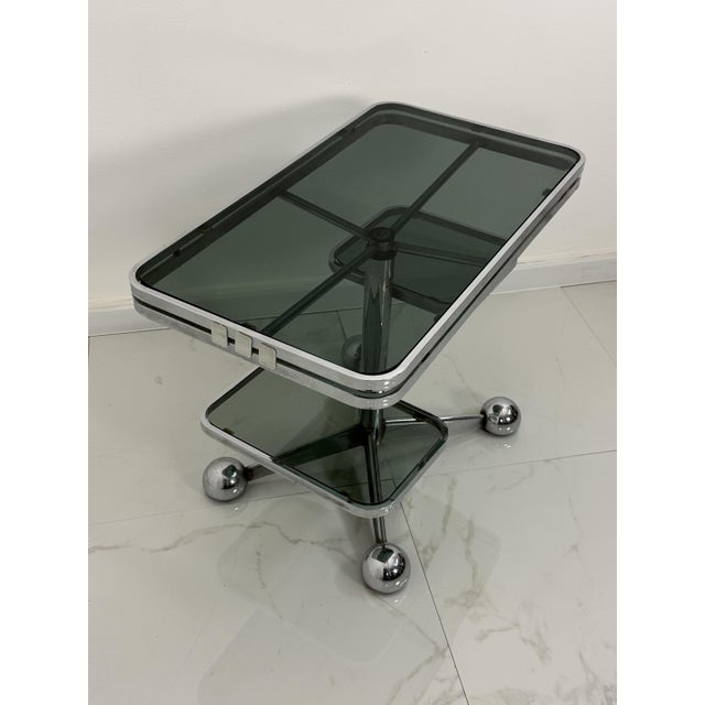 "Allegri Parma" coffee table with wheels, 1970s Good condition, intact glass, minor signs of wear. Width 78.4 cm Depth 44...
