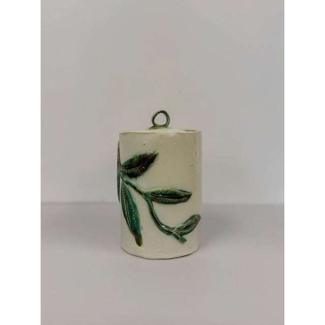 This lovely vintage studio pottery jar with lid is a beautifully handcrafted ceramic find. The intricate vine and leaf...