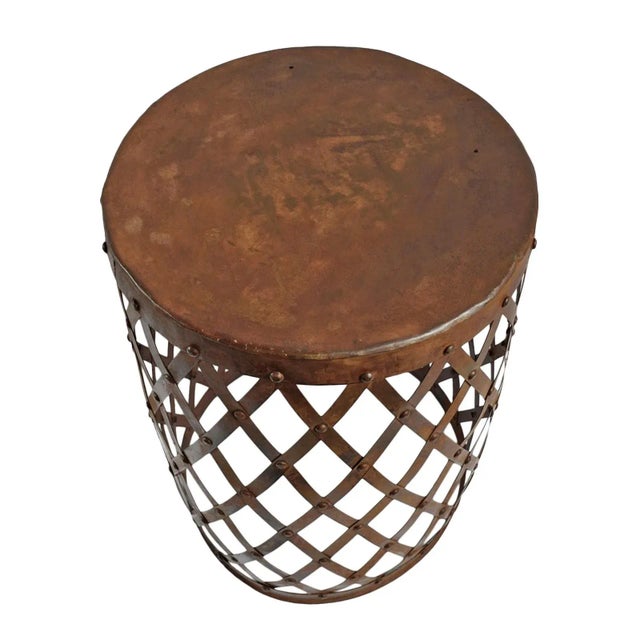 Aged vintage rusted iron barrel side table with diamond shape lattice weave design. Each may vary in patina and natural...