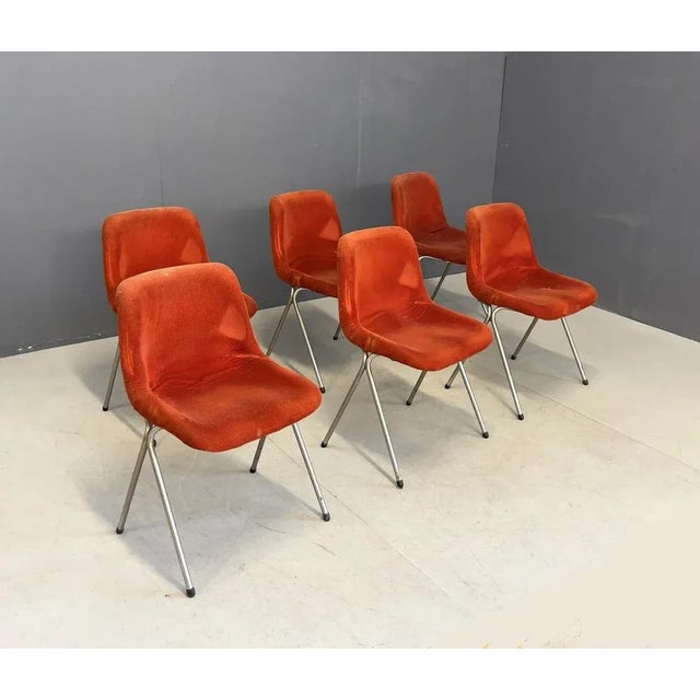 Six chairs with chromed metal structure, plastic material and red fabric covering. Italian manufacture. 1960s.