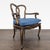 This classic dining chair features a solid wood frame with a curved back, cabriole legs, and carved armrests. The seat is...