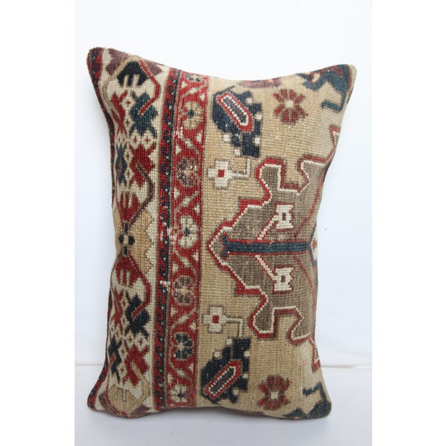 This handcrafted lumbar pillow cover is made from a vintage tribal Turkish Rug, showcasing a beautifully aged patina and...