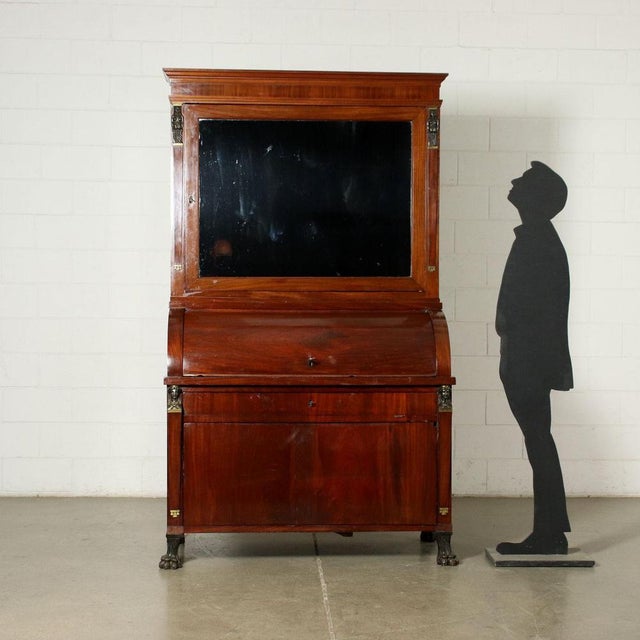 Central Italy Empire desk, supported by lion feet, on the front it has a retractable door, which can be opened through a...