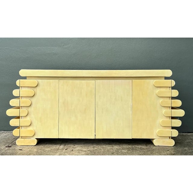 This vintage credenza is defined by its bold, sculptural side panels, each built from a stacked column of rounded, tubular...