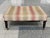 A classic George Smith ottoman upholstered in a colorful, floral-and-stripe patterned weave. The turned wooden legs...