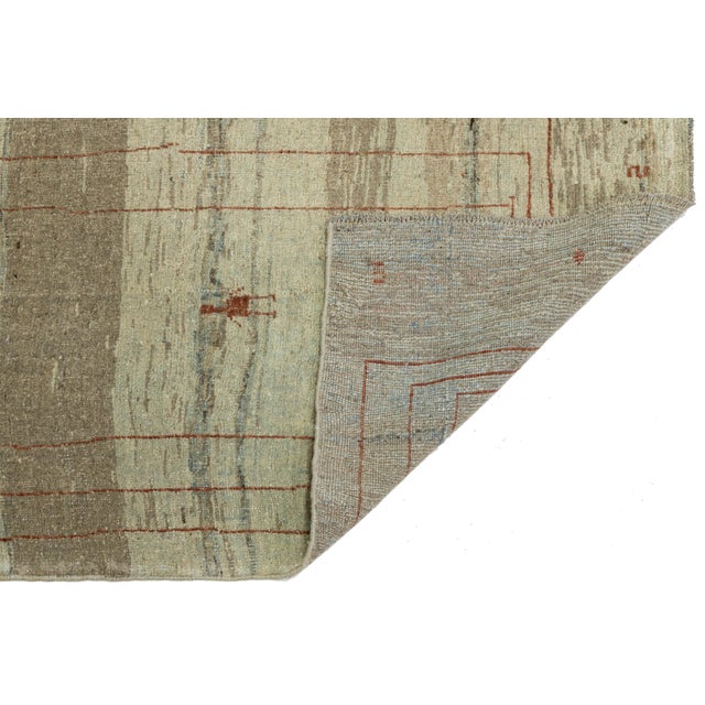Elevate your space with this hand-knotted Modern Gabbeh Runner, crafted from 100% premium hand-spun wool. It features a...