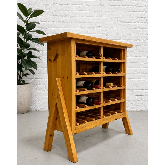 Scandinavian Mid Century Modern Pine Wine rack featuring a floating leg design, c. 1970’s. Made from solid pine and holds...