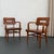This pair of American Mid-Century Modern armchairs by the W. H. Gunlocke Chair Co. feature newly finished solid walnut...
