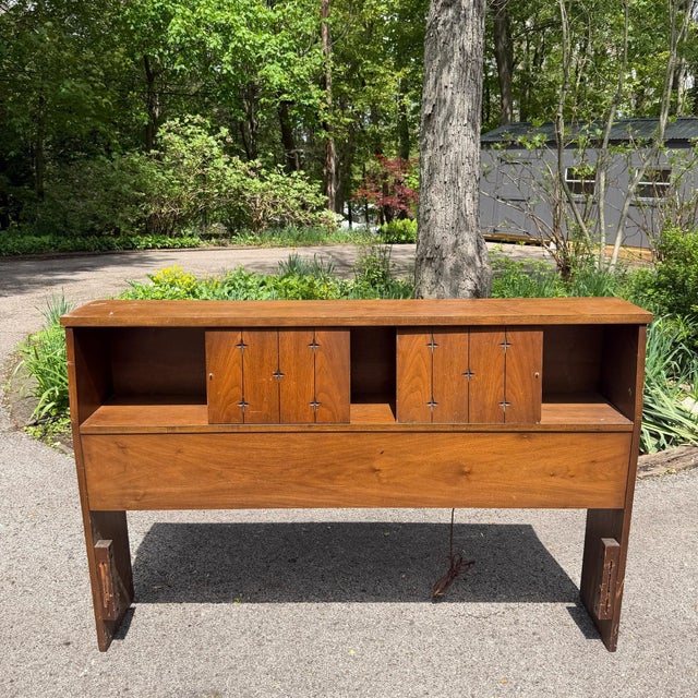 Mid-century walnut Full size headboard by Broyhill from their Saga line, featuring integrated storage and distinctive...