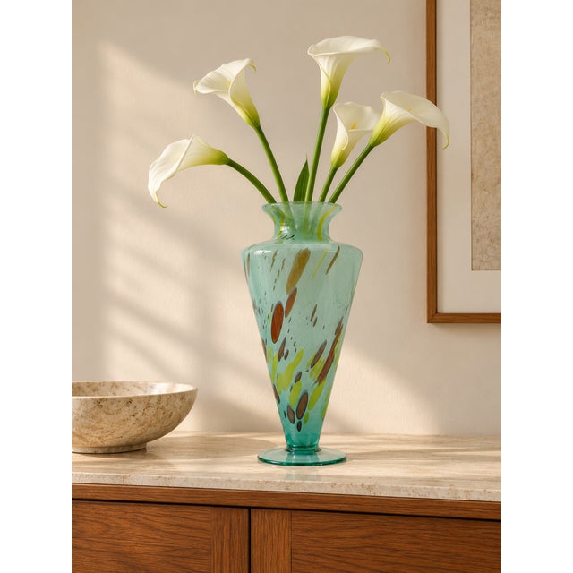 A striking vintage Murano art glass vase by Milano Lavorazione, featuring a translucent aqua-blue body with expressive...