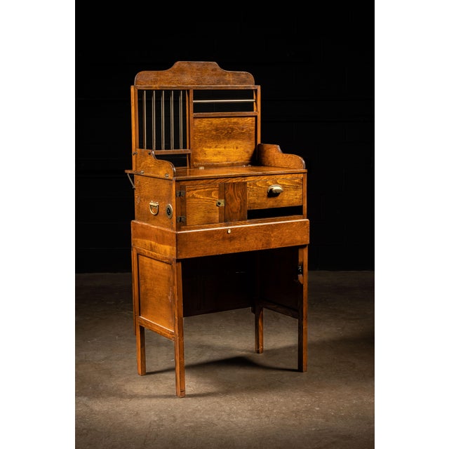 Unusual early 20th-century folding teller desk believed to have been designed for portable use aboard a railroad train....