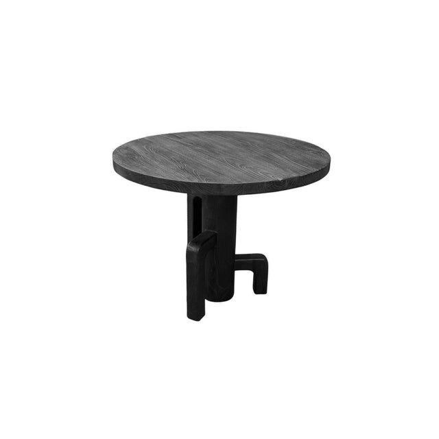 This sculptural teak wood dining table is a powerful statement of form and craftsmanship. Finished in a deep matte black,...