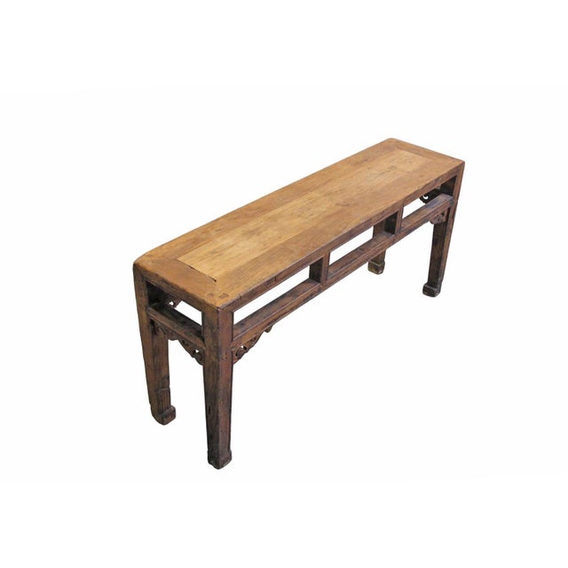 This antique Chinese altar bench showcases a blend of traditional craftsmanship with its decorative hand-carved spandrels....