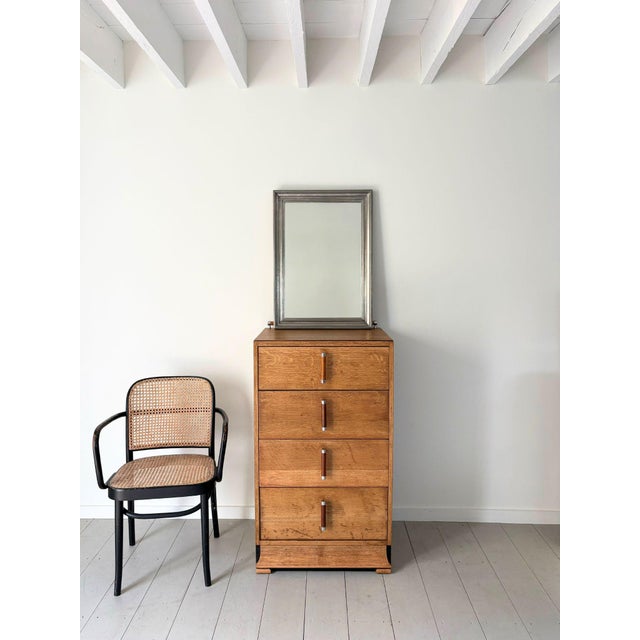 A sleek french mirror with impressed tin frame. This 20th century vintage wall mirror has a multi reeded and moulded...