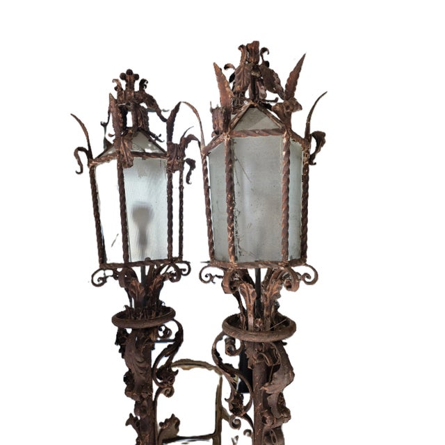 Beautiful ornate iron lanterns wired and were housed outside under a covered walkway. They work inside and outside.