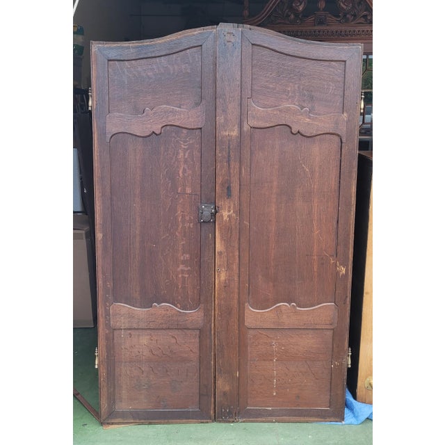 A fine pair of French antique oak carved interior doors. Each door features carved Stars at the base at the top ribbons of...
