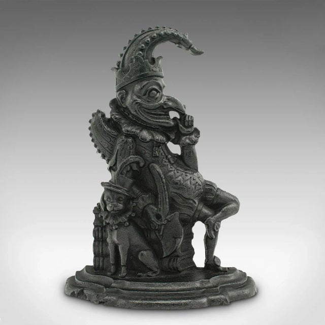 This is an antique Mr. Punch doorstop. An English, cast iron figurative door keeper, dating to the Victorian period, circa...