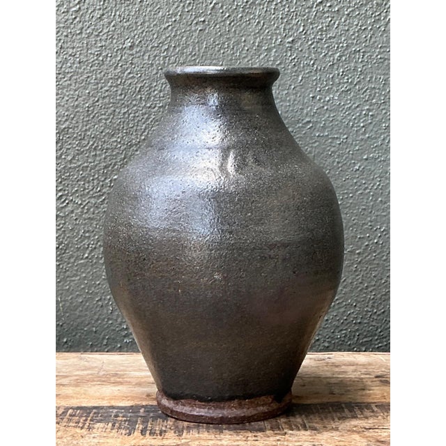 This vintage handcrafted stoneware vase is a striking example of mid-century studio pottery, blending sculptural...