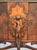 An unusual demilune low cabinet with bookmatched burl walnut doors flanking a marquetry center panel, mounted with a...
