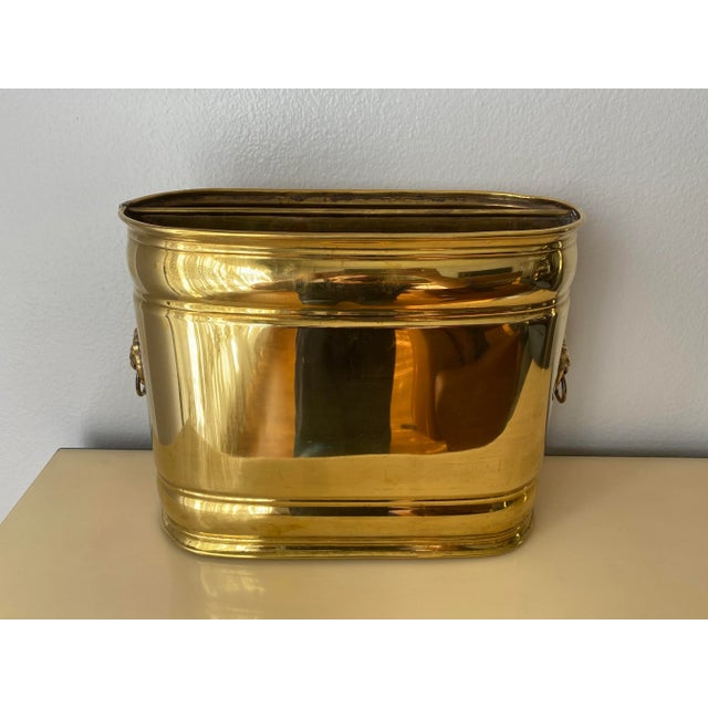 Brass lion motif magazine holder.