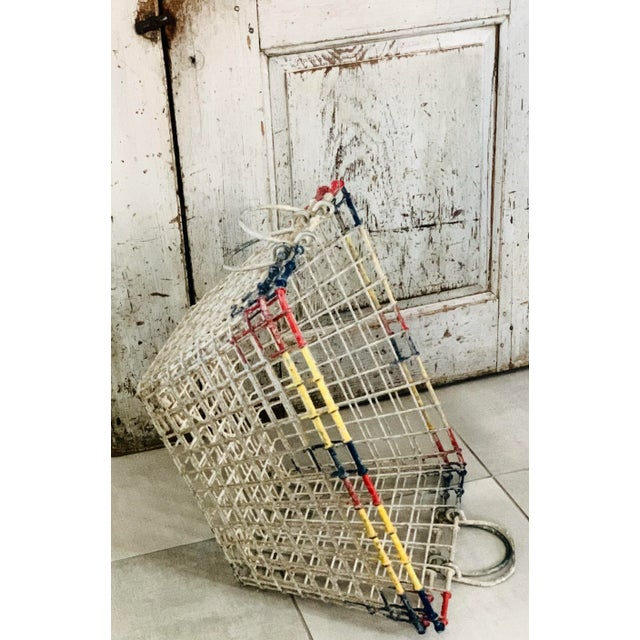 A pair of 1930's vintage French wire mesh oyster baskets, each with two wire folding handles. Original unrestored...