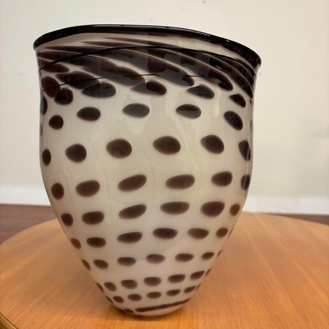 Add sculptural flair to your space with this stunning handblown glass vessel by American glass artist Brian Heritage....