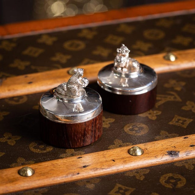 A 20th century pair of vintage novelty solid silver trinket boxes. Featuring a perched squirrel holding a berry with a...