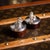 A 20th century pair of vintage novelty solid silver trinket boxes. Featuring a perched squirrel holding a berry with a...