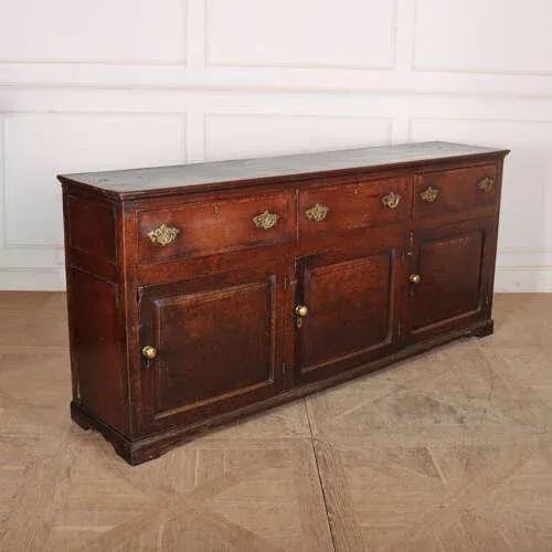 18th century English oak dresser base with cross banded drawers. 1760. This piece is designed in the style of the selected...