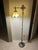 This item is a vintage Tiffany-style bridge arm floor lamp, characterized by its decorative metal base and leaded stained...